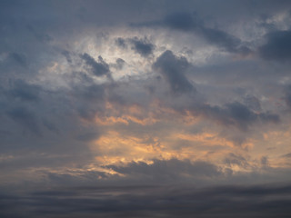 Beautiful multi-colored sky with clouds and light rays of the sun in the evening at sunset. Calm sky background for decoration.