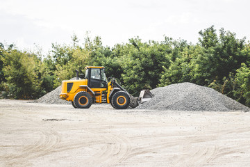 Unload bulk cargo with of the cargo railway platform in the mining quarry