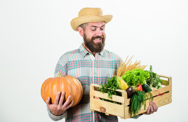 Farmer carry harvest. Farmer lifestyle professional occupation. Buy local foods. Farmer rustic bearded man hold wooden box with homegrown vegetables and pumpkin white background. Locally grown foods