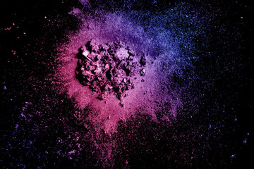 Crushed eye shadow texture. Neon palette make up powder swatch isolated on black background