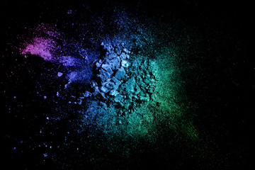 Crushed eyeshadow texture. Neon palette makeup powder swatch isolated on black background - obrazy, fototapety, plakaty