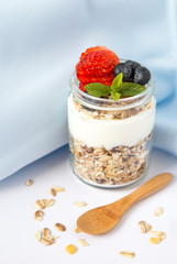 Healthy breakfast with yogurt, muesli, berries and strawberries