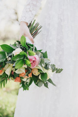 Bride holding wedding bouquet.