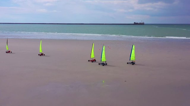 Aerial land carts sail carts blokarts sand yachts are sailed on the beach in France.