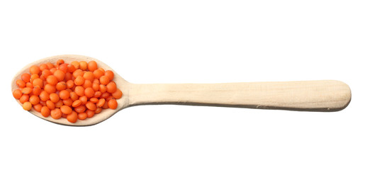 red lentils in wooden spoon isolated on white background. Top view.