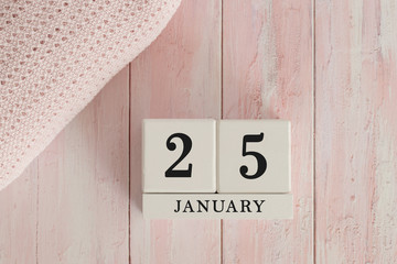 25 January Date on Cubes. Date on painted pink wood, next to baby blanket. Theme of baby due dates...