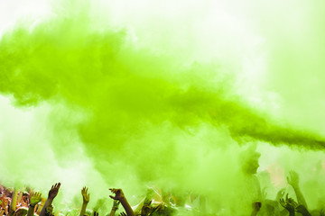 Explosion of green holi color over the crowd