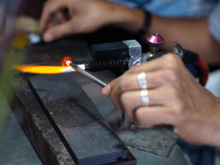 Process of glass bead at work. Glass Artist in his workshop