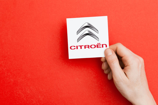 LONDON, UK - October 26th 2018: Hand holding a Citroen logo. Citroen is an automobile manufacturer.
