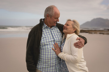 Senior couple embracing each other on the beach