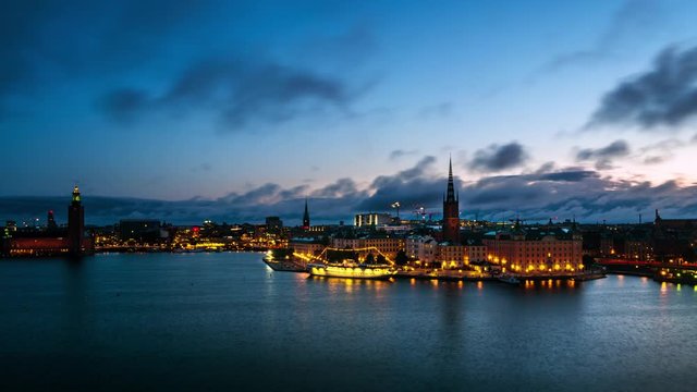 Stockholm, Sweden. Time-lapse of Gamla Stan in Stockholm, Sweden with landmarks like Riddarholm Church during the sunrise. View of old buildings and cloudy sky in morning