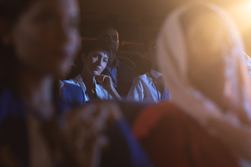 Businesswoman sitting and listening to the presentation with audience