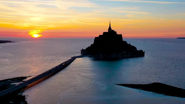 Amazing aerial of Mont Saint-Michel France silhouetted at sunset.