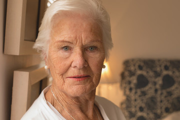 Senior woman relaxing in bedroom at home
