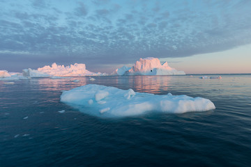 Huge icebergs of different forms in the Disko Bay, West Greenland. Their source is by the...