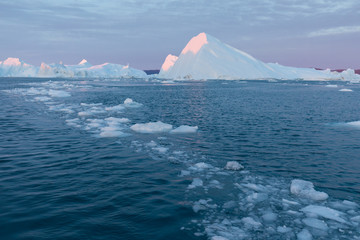 Huge icebergs of different forms in the Disko Bay, West Greenland. Their source is by the...