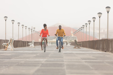 Couple riding bicycle at promenade on a sunny day
