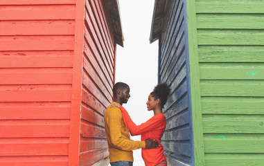 Fototapeta premium Romantic couple looking at each other between beach huts