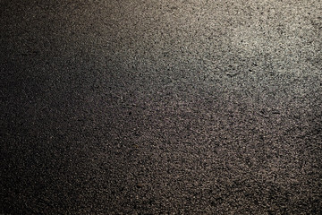 wet asphalt road with sunny texture
