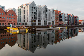 arly morning in the city of Gdansk in Northern Poland. Reflections in river of houses, water is like mirror. © siv2203