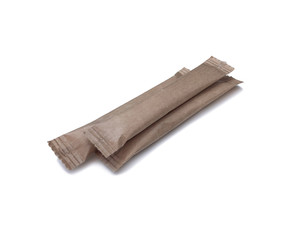 Paper brown sticks for sugar, salt, coffee and spices on a white background with a sunny shadow. Eco packaging for bulk products.