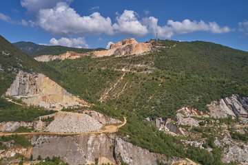 Fototapeta na wymiar Air view of a marble quarry. Panoramic view of the extraction of marble in the quarry. Technique in the marble quarry of Brescia, Italy. Open pit mine.