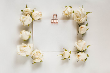 White paper card stationery mockup. Romantic flat lay with roses