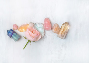 set gemstones crystal minerals for relaxation and meditation and rose flower. Magic Rock for Crystal Ritual, Witchcraft. Crystal Layout for Relaxing Chakra. Healing stones on white table. soft focus