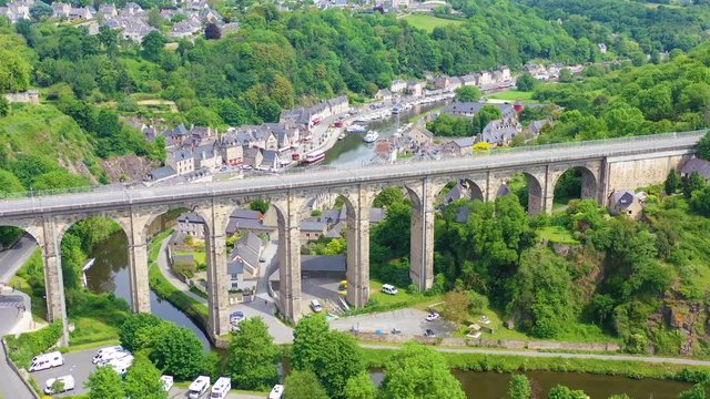 Aerial over the pretty town of Dinan, France with highway bridge.