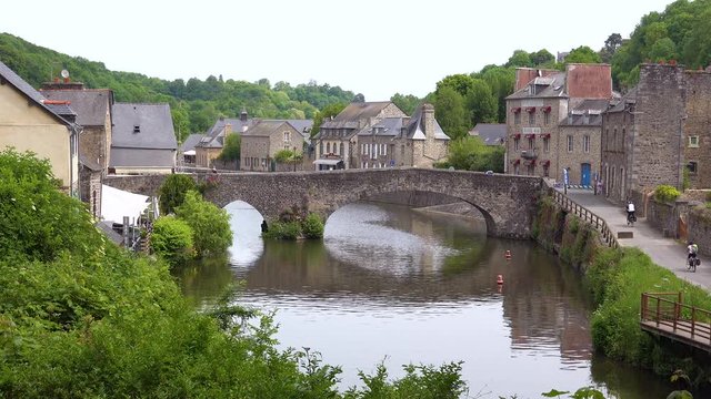 Establishing the pretty town of Dinan, France with tourists and bicycles.