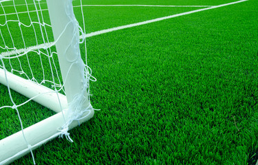 Artificial green grass with white stripe  on sports fields for soccer and football.