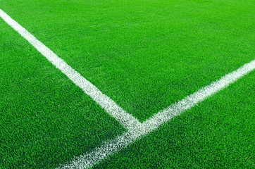 Obraz premium Artificial green grass with white stripe on sports fields for soccer and football.