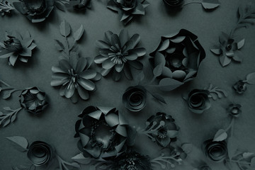 Obraz na płótnie Canvas Black paper flowers on Black background. Cut from paper.