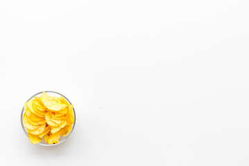 Potato chips in bowl ready to eat on white background top view mock up