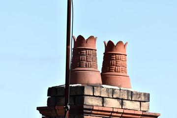 Decorative chimney stacks on brick base