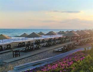 beach sun loungers and the sea in the sunset