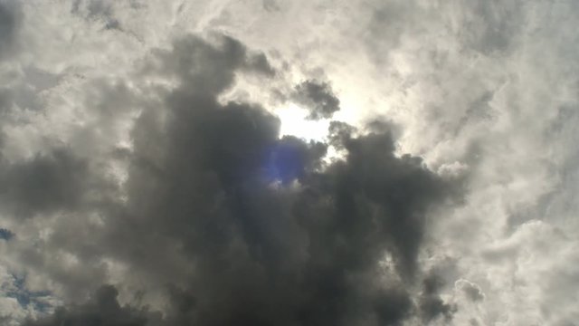 Sun obscured by dark clouds