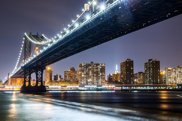 Manhattan bridge at night with Empire State Building in the background