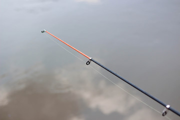 Fishing rod on the background of the river. Close up