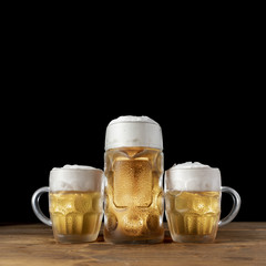 Set of beer mugs on a wooden table