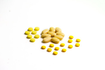 Close up assorted medical drugs, antibiotic pharmaceutical medicine pills and syringe isolated on white background. Yellow tablets pills with copy space. Medicine and healthy concept.