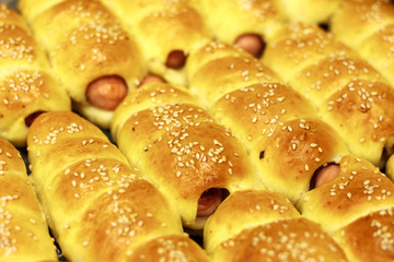 Fresh tasty sausages in dough close up