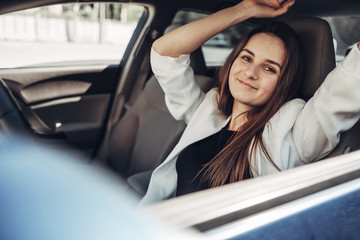 Fashion Stylish Driver Girl in White Suit Sitting in the Car