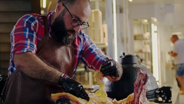 Chef cutting beef carcass in a restaurant