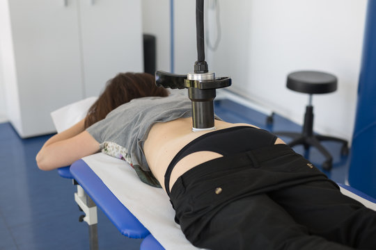 Diamagnetic Pump for Pain Therapy: Woman lying on aBed Undergoing Therapy