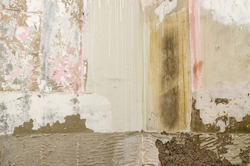 Bathroom wall with scarped old paint during reconstruction works in an apartment