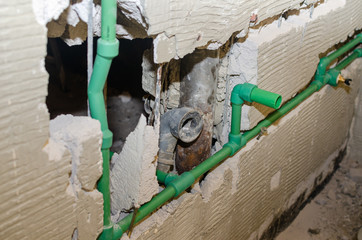 Plastic water pipes of a new generation installed in a chased bathroom wall during renovation works