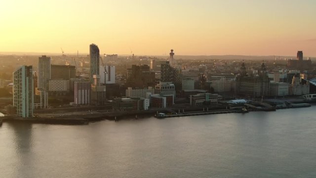 liverpool city aerial view at sunrise rising up from mersey river over waterfront uk england