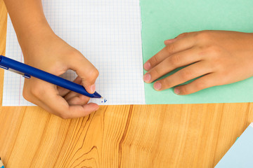 girl begins to write from scratch in a new notebook
