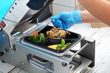 Packing food in trays. Restaurant takeaway food